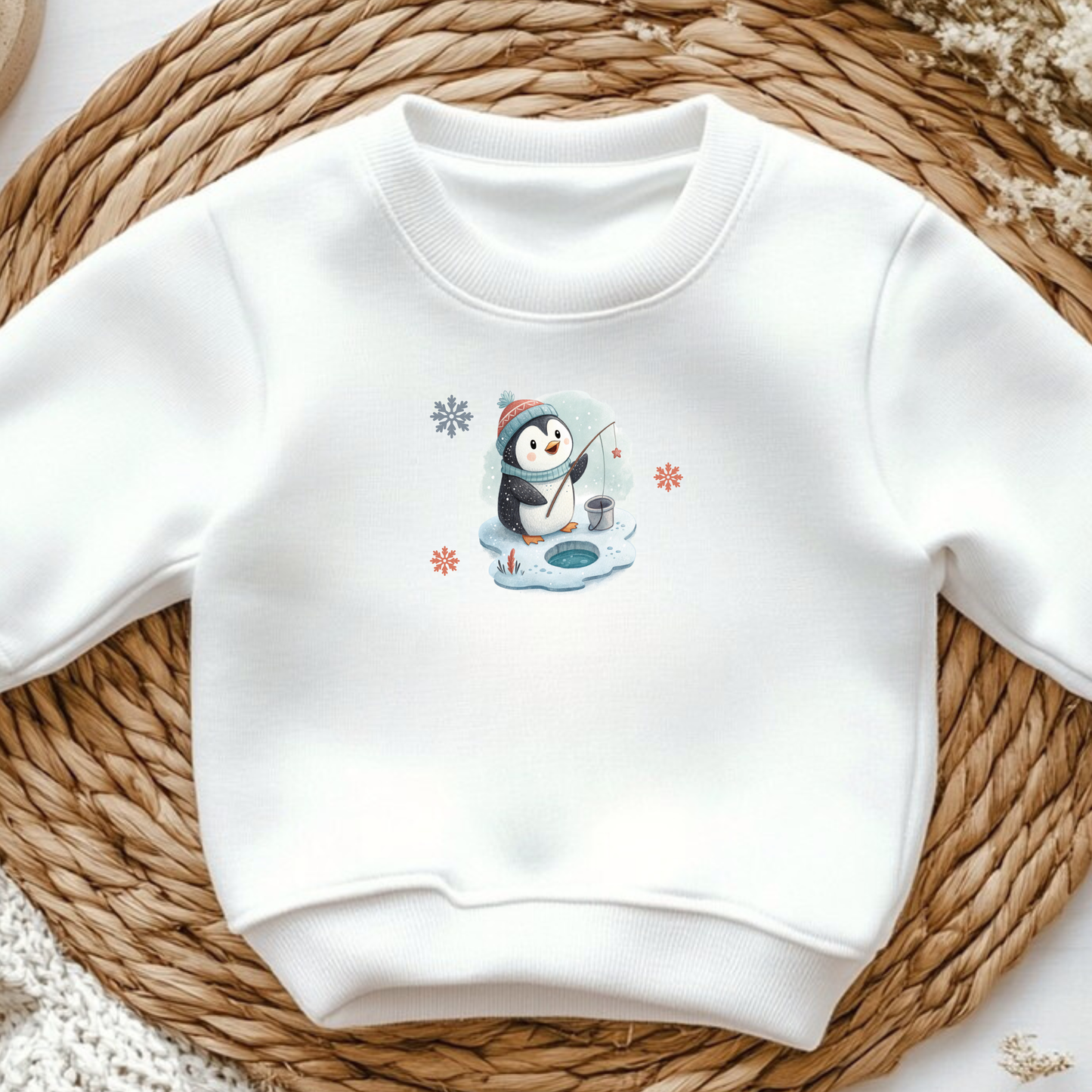 White sweatshirt with cute winter penguin ice fishing iron-on design, snowflakes accent