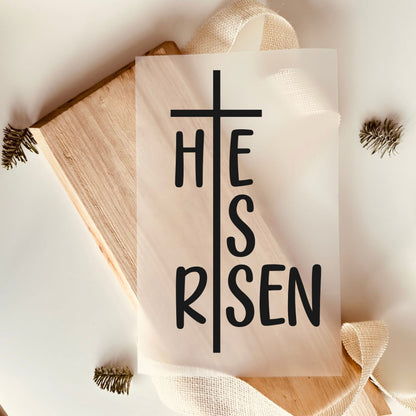 Christian iron-on transfer with 'He is Risen' cross design on wood background, Easter craft supply