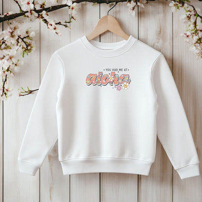 Bügelbild mit bunten Retro-Blumen und Smiley-Motiven, hier als Beispiel aufgebügelt